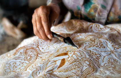 A woman working on Batik painting